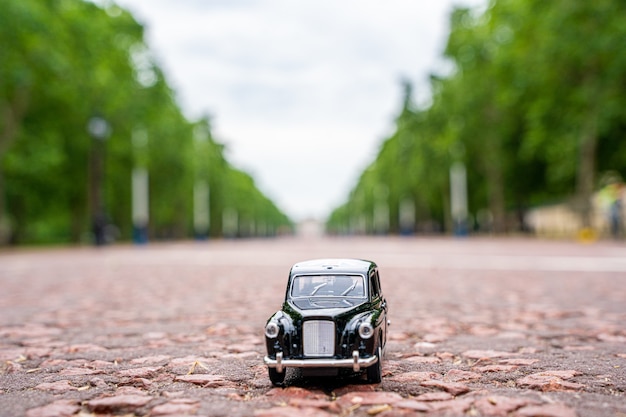 Closeup shot of a traditional black cab driving through the most famous landmarks in London