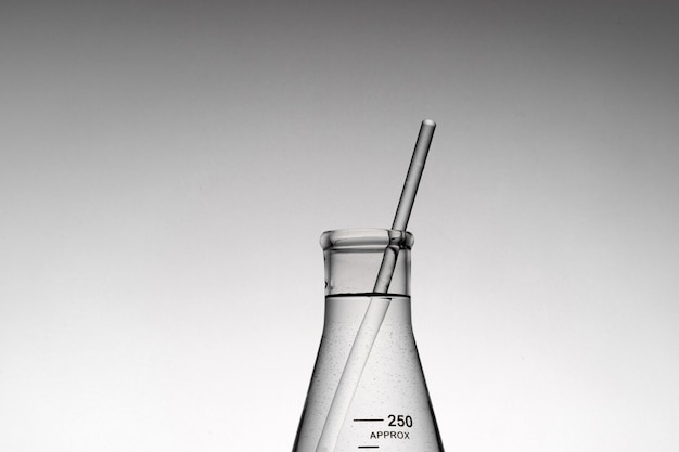 Closeup shot of a tube inside an Erlenmeyer beaker