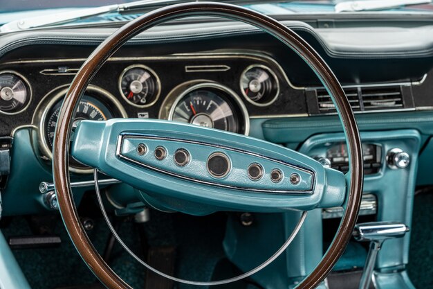 Closeup shot of a turquoise interior of a car, including the steering wheel