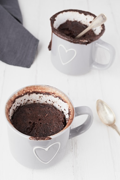 Closeup shot of two cups of coffee isolated on a white surface