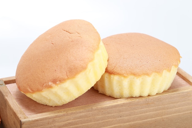 Closeup shot of two delicious freshly baked cupcakes on a wooden box