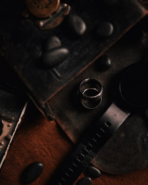 Closeup shot of two silver rings on a leather surface