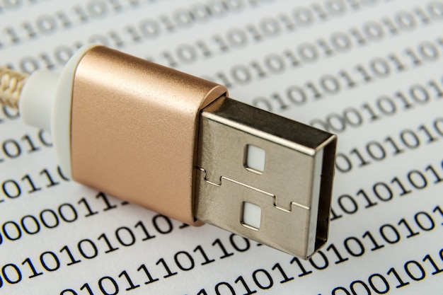 Free photo closeup shot of a usb cable on a piece of paper with numbers and codes written on it