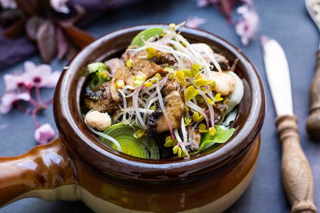 Closeup shot of a vegan meal with mushrooms, onions, carrots and leek