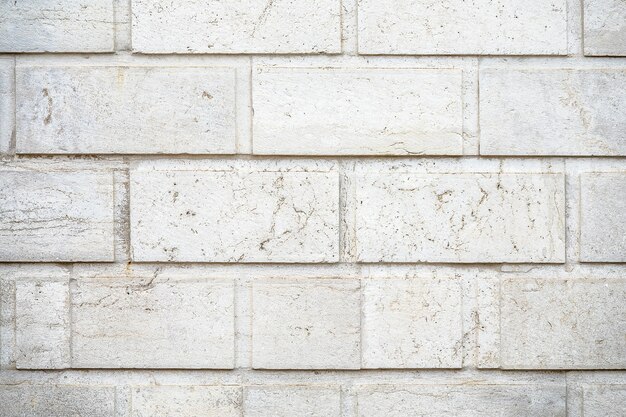 Closeup shot of a wall made of white rectangular stones background