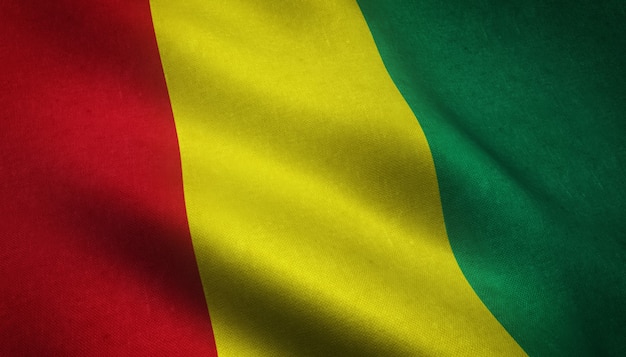 Closeup shot of the waving flag of Guinea with interesting textures