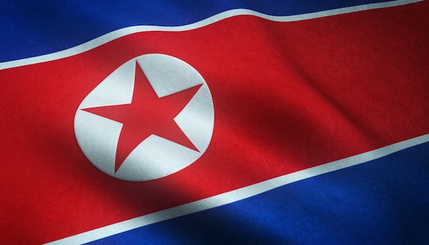 興味深いテクスチャを持つ北朝鮮の旗を振っているのクローズアップショット