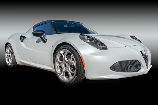 Closeup shot of a white car in a dark background