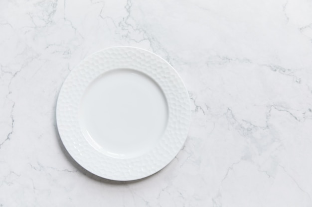 Closeup shot of a white plate on a colored background