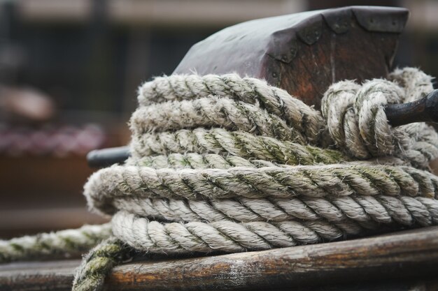 Closeup shot of a white rope tied on wood