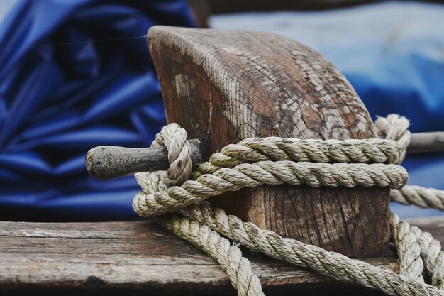 Closeup shot of a white rope tied on wood