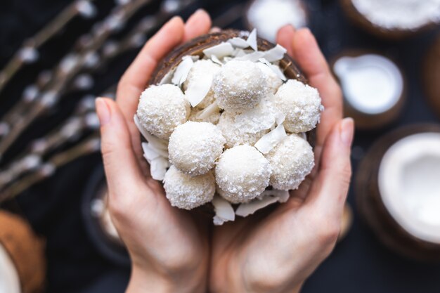 Closeup shot of a woman holding a bowl of delicious raffaello