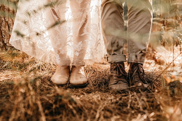 Closeup shot of a woman's legs in a white dress and white boot