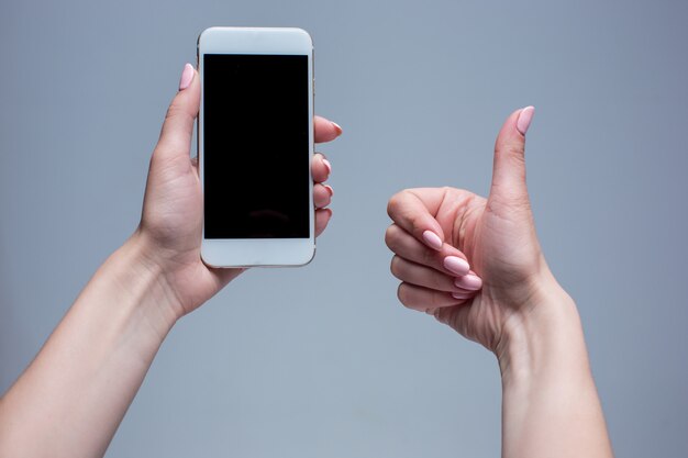 Closeup shot of a woman typing on mobile phone