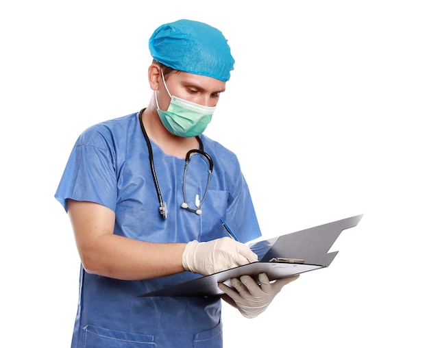 Closeup shot of a young male doctor looking at records isolated on white wall