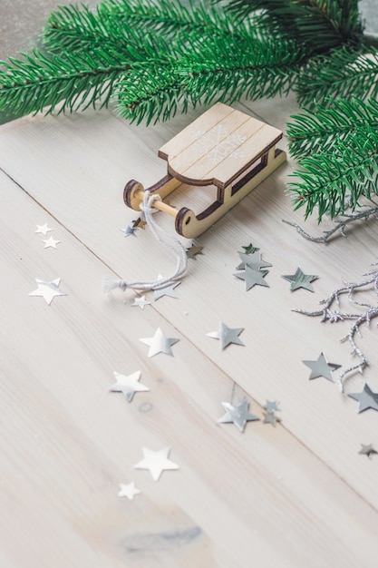 Closeup of a small wooden sledge ornament on the table under the lights