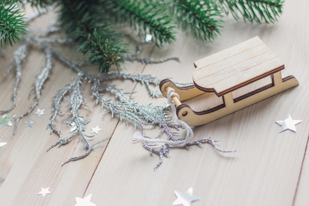 Closeup of a small wooden sledge ornament on the table