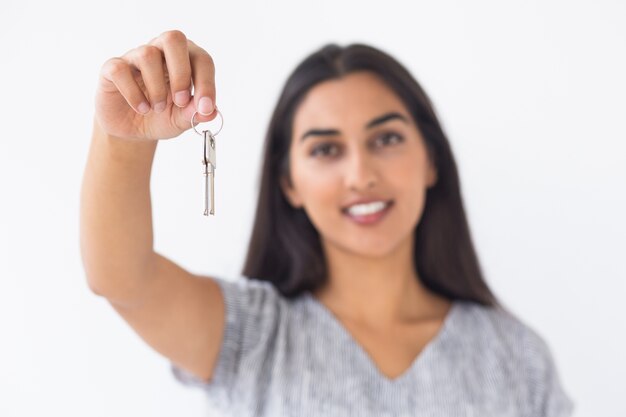 Closeup of Smiling Blurred Woman Raising Keys