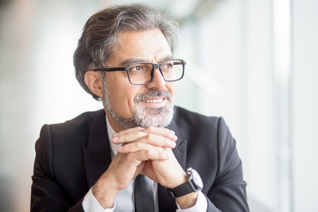 Closeup of Smiling Business Man Sitting at Window