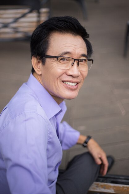 Closeup of Smiling Senior Man Sitting on Bench