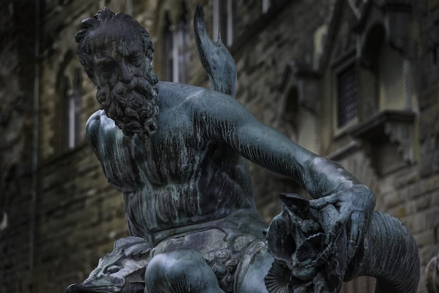 Closeup of the statue in Fountain of Neptune in Florence, Italy, during daylight
