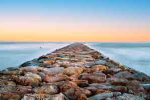 Free photo closeup of a stone walkway on the sea with