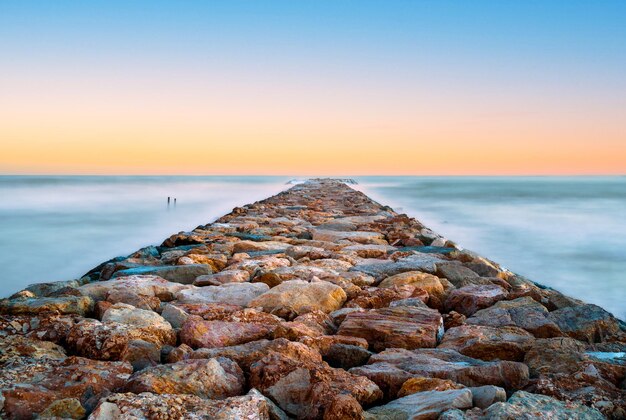 Closeup of a stone walkway on the sea with