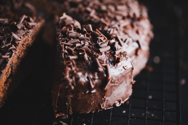 Closeup of tasty chocolate cake with chocolate chunks on baking sheet.