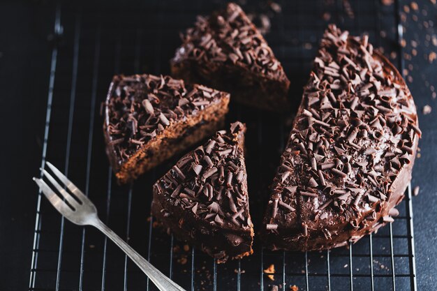 Closeup of tasty chocolate cake with chocolate chunks on baking sheet.