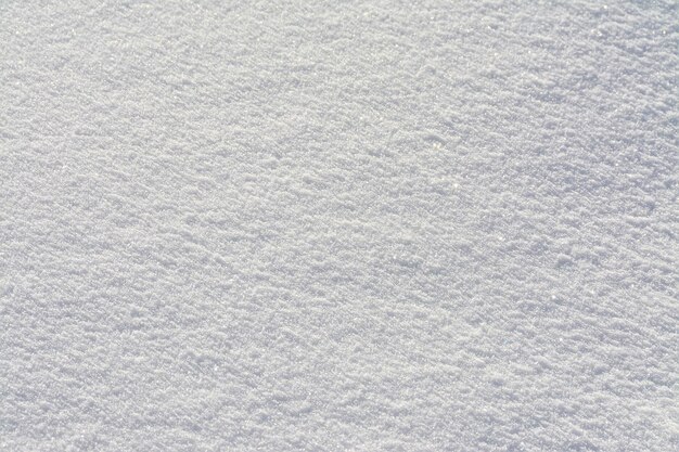 新鮮な白い雪の表面のクローズアップテクスチャ