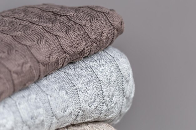 Closeup of textured knitted blankets in a stack