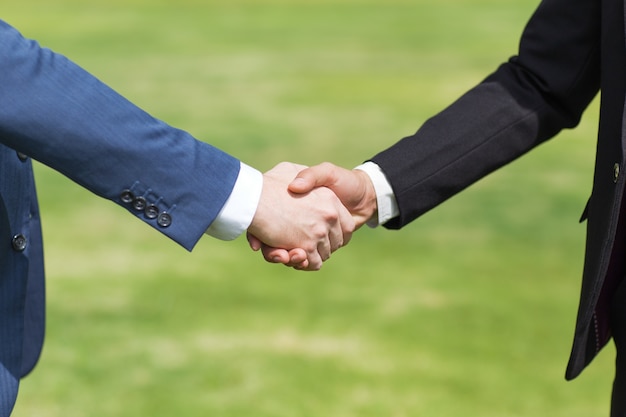 Free photo closeup of two business men shaking hands