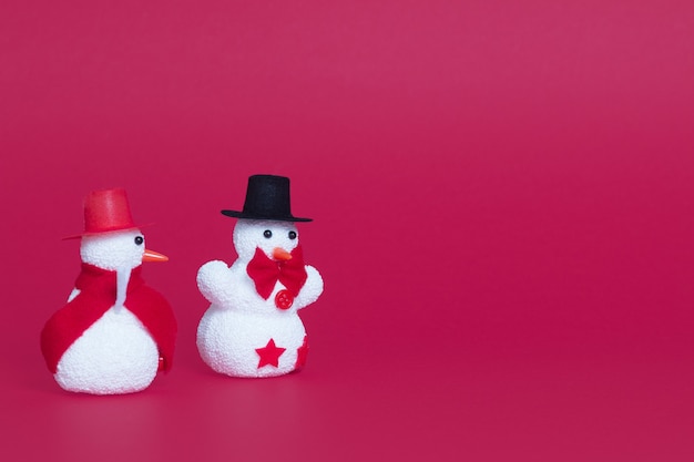 Closeup of two cute snowmen as Christmas ornaments
