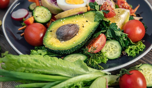 Closeup vegetable salad with avocado and eggs