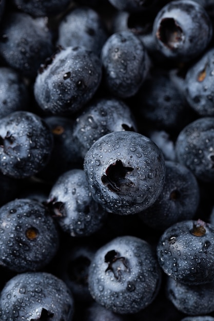 Closeup vertical shot of blueberries with water droplets