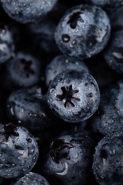 Closeup vertical shot of blueberries with water droplets