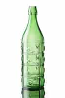 Free photo closeup vertical shot of a green glass bottle isolated on white background