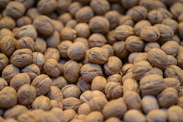 Closeup of walnuts under the lights in a market with a blurry background - perfect for food concepts