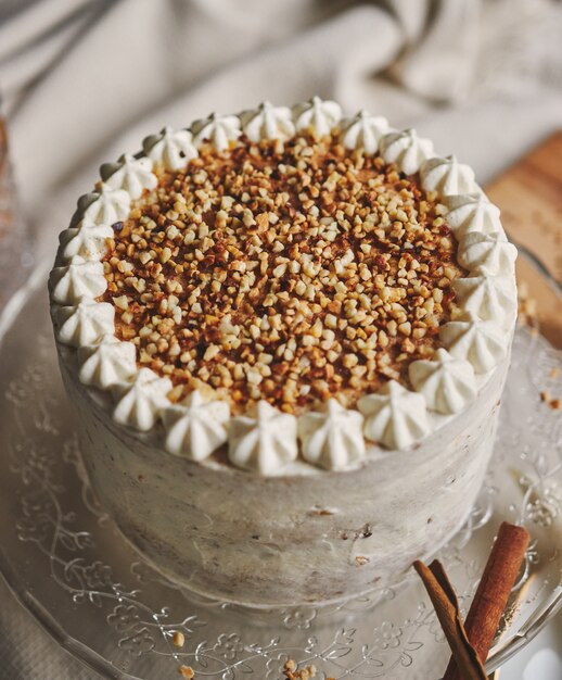 Closeup of a white delicious Christmas cake with nuts and mandarine