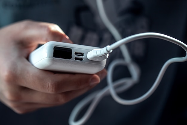 Free photo closeup of a white power bank in a female hand