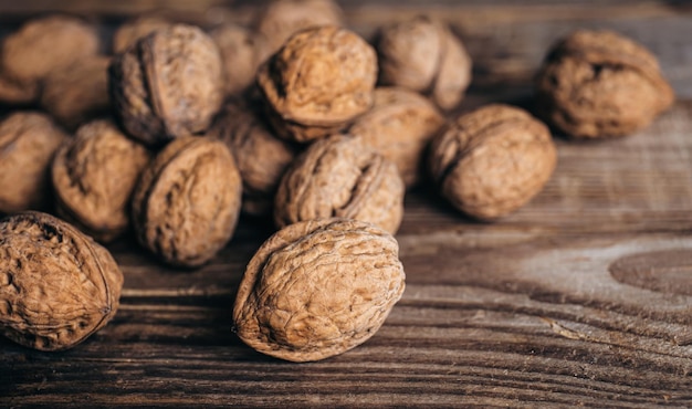 Free photo closeup whole walnuts on a wooden background rustic style