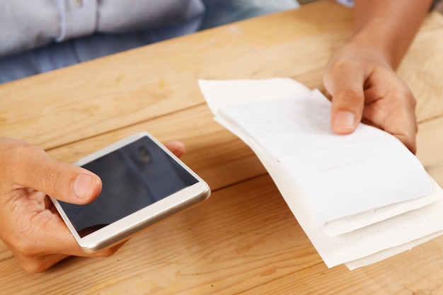 Closeup of woman calculating or paying bills