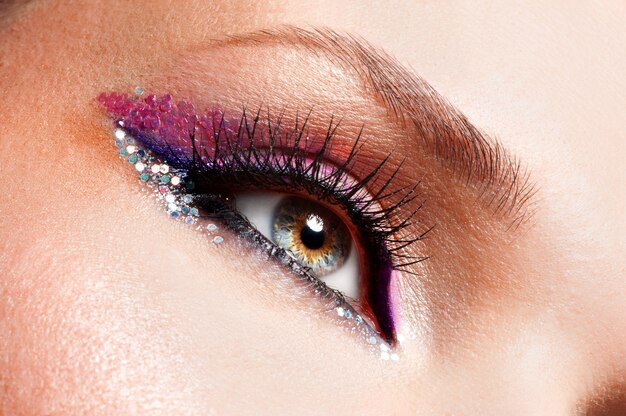 Closeup woman eyes with beautiful fashion bright pink make-up