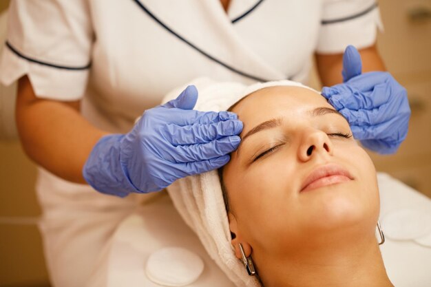Closeup of woman having facial massage during beauty treatment at the spa