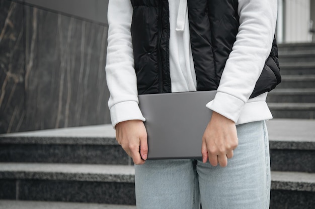 Free photo closeup a woman is using a tablet outside