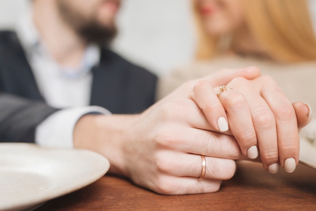 Closeup of woman and man holding hands