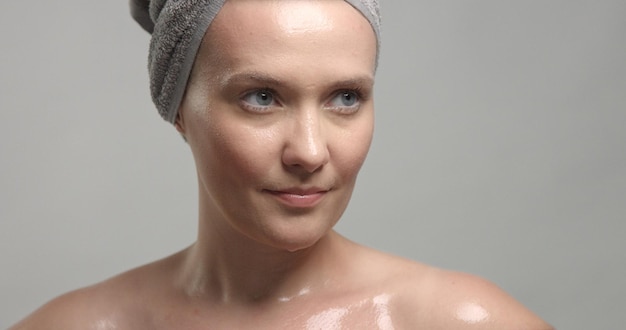 Closeup of woman's face with wet skin with drops of water on it Mousturizing skin concept