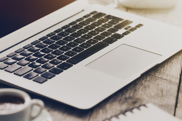 Closeup of Workspace with Modern Creative Laptop, Cup of Coffee and Pencils. Horizontal with Copy Space. 