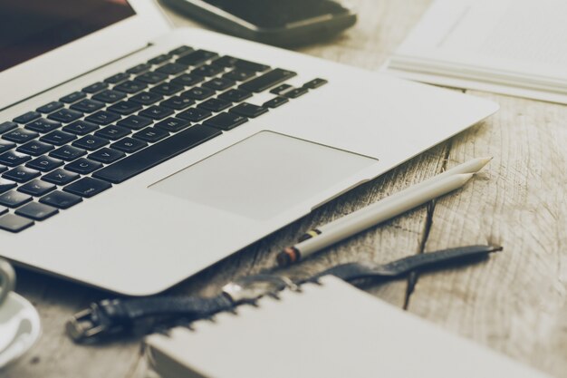 Closeup of Workspace with Modern Creative Laptop, Cup of Coffee and Pencils. Horizontal with Copy Space. 