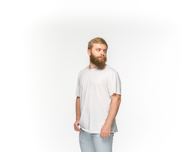 Closeup of young man's body in empty white t-shirt isolated on white background. Clothing, mock up for disign concept with copy space. Front view